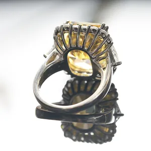 Macro shot of 10-carat radiant cut yellow diamond ring showing detailed silver setting