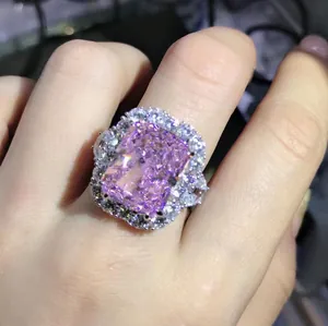Close-up of 10-carat radiant cut pink high-carbon diamond ring with halo setting
