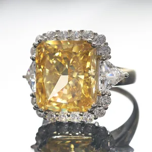 Macro shot of 10-carat radiant yellow diamond ring with triangular side stones and halo