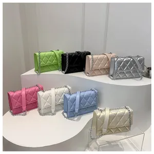 Collection of quilted chain shoulder bags in multiple colors on a white tiered display