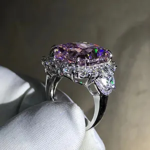 Macro detail of high-carat radiant cut pink gemstone ring with halo diamond pavé setting