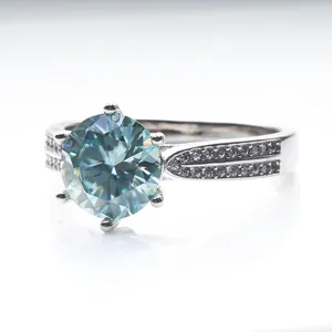 Blue moissanite ring with six-prong setting and side accent diamonds on silver band