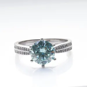 Classic six-prong sterling silver ring with a round blue moissanite and micro-pave diamonds