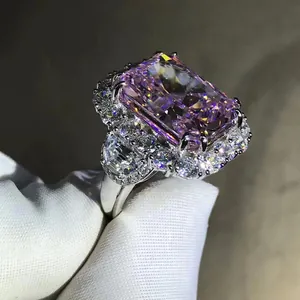 Macro view of large radiant cut pink carbon diamond ring with side accent stones