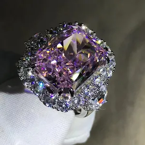 Macro shot of 10-carat radiant cut pink gemstone ring with halo diamond setting