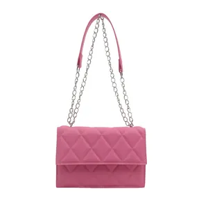 Pink quilted crossbody bag with silver chain strap on a white background
