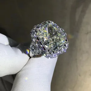 Macro shot of 10-carat radiant cut yellow diamond ring with white pavé diamond halo