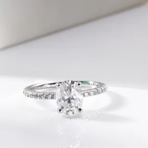 Elegant 2 carat oval cut moissanite ring with four-prong setting and side diamonds
