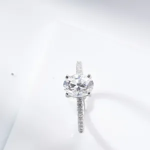 Close-up of 2ct oval cut moissanite ring with four-prong setting and pavé band details