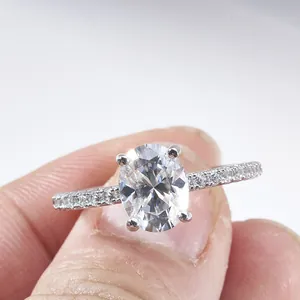 Elegant 2 carat oval cut moissanite ring with pavé diamond shank in white gold finish