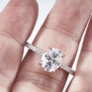 2ct oval cut moissanite ring with four-prong setting and side diamonds on silver band