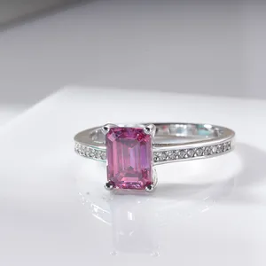 Macro shot of silver ring featuring radiant cut pink moissanite and pave diamonds