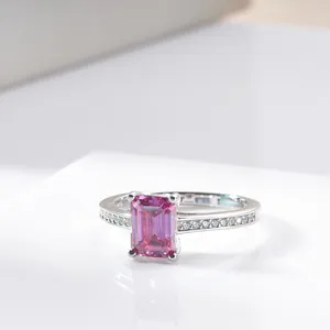 Macro shot of s925 silver ring featuring radiant emerald cut pink moissanite and side stones