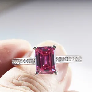 S925 silver ring with radiant cut emerald shape magenta moissanite held by fingers