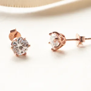 Macro detail of rose gold moissanite studs featuring 925 sterling silver hallmark stamp
