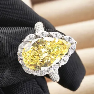 6ct Pear cut yellow carbon diamond ring with marquise halo on a silver band