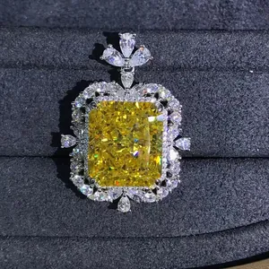 Radiant cut 15ct yellow carbon diamond pendant in silver setting on velvet background