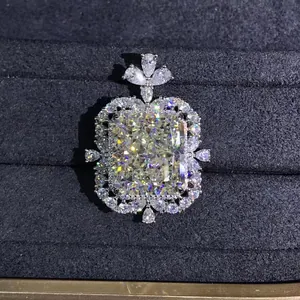 Detailed macro view of radiant cut yellow gemstone pendant with double halo diamond accents