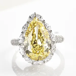 Luxury 6-carat pear cut yellow diamond ring with halo cluster in polished white gold