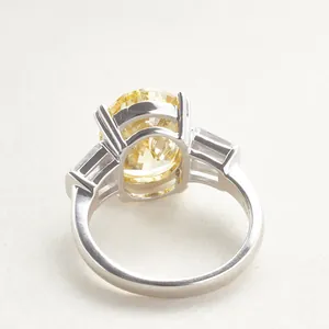 6 carat oval yellow carbon diamond ring in silver setting with side stones