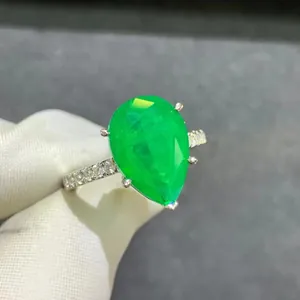 6 carat pear cut emerald ring in platinum plated silver with sparkling pavé diamonds