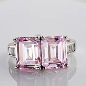 Luxury sterling silver ring featuring two emerald cut pink diamonds with side stones