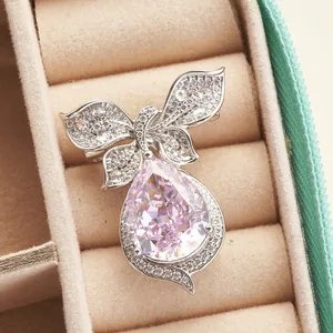 10ct pear cut pink high carbon diamond bow pendant in sterling silver on velvet