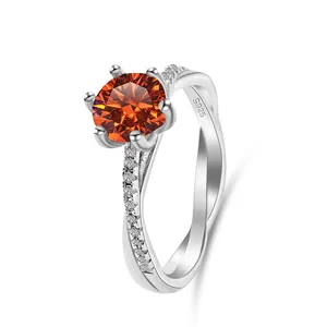 Macro shot of 1ct orange moissanite with 925 silver six-prong twisted band setting
