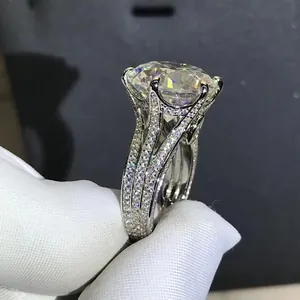 Macro shot of 12-carat round cut stone ring with three rows of pavé set side diamonds