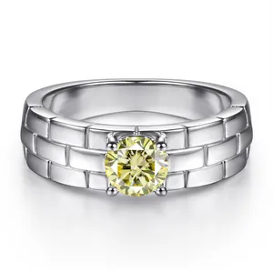 Detail of 5mm 0.5ct yellow moissanite ring with textured watch band silver shank