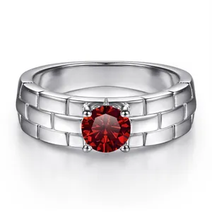 Detailed view of silver watch-band style ring featuring a red center stone and brick pattern