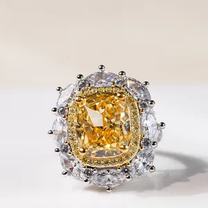 Macro shot of 8-carat cushion-cut yellow diamond ring with floral halo in silver