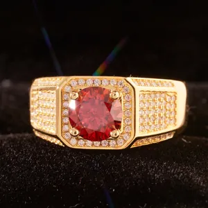 Luxury gold ring for men featuring a large red round gemstone and pavé-set side stones