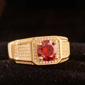 Luxurious gold moissanite ring with large round red center stone and halo design