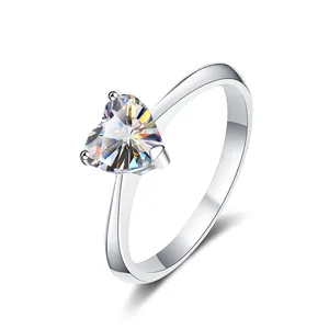 Close-up of heart-cut moissanite silver ring showcasing exquisite fire and 3-prong setting