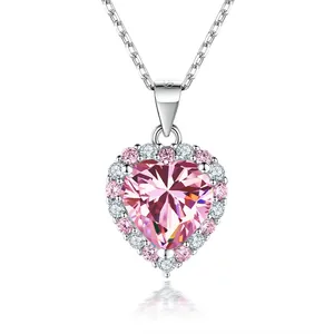 Close-up of heart-shaped pink moissanite pendant with halo diamonds in silver chain