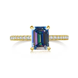 Macro view of emerald cut pink moissanite ring with gold band and side pavé diamonds