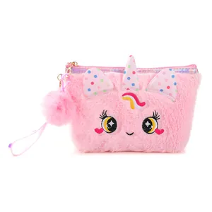 Close-up of pink plush unicorn pouch featuring star-eye embroidery and rainbow detail