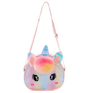 Detailed view of kids unicorn crossbody bag with glitter finish and plush pom-poms