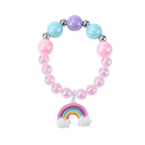 Detail of colorful children's beaded bracelet with a glittery rainbow cloud pendant