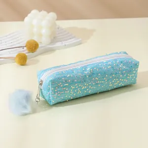 Sparkly blue sequin pencil case with white zipper and a soft fluffy pompom keychain