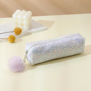 Macro detail of rainbow sequin pencil case featuring a purple pompom and top zipper