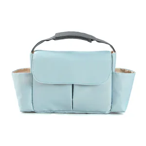 Detail of light blue stroller organizer bag featuring side pockets and velcro straps