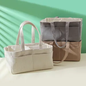 Corduroy baby diaper organizer with multiple compartments in cream, grey, and brown