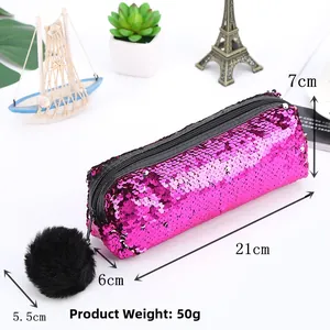 Detail showing 21x7x6cm dimensions of fuchsia sequin pouch with black pompom charm