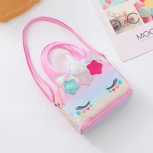 Macro detail of sparkly unicorn crossbody bag with glitter stars and rainbow texture