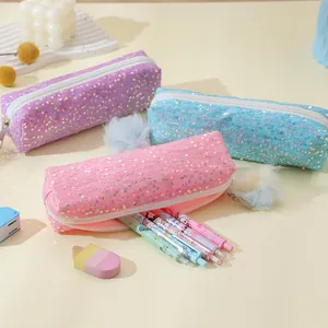 Close-up of three-piece glitter pencil case set in pink blue and purple with plush charms