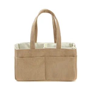Close-up of corduroy diaper bag organizer showing beige ribbed texture and inner compartments