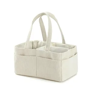 Detail view of corduroy diaper bag showing internal dividers and side pockets