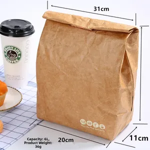 Brown Tyvek paper insulated lunch bag with 6L capacity on a dining table scene